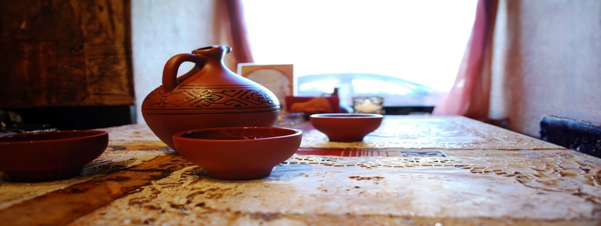 Table with Georgian Wine in a clay pitcher